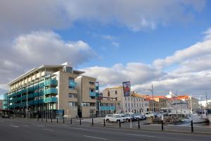 a city street with cars parked in front of a building at Zero Davey Boutique Apartment Hotel in Hobart