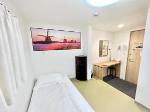 Pokój szpitalny z łóżkiem i biurkiem w obiekcie da inn w Osace