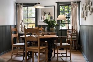 a dining room with a table and chairs at Innisfree in Daylesford