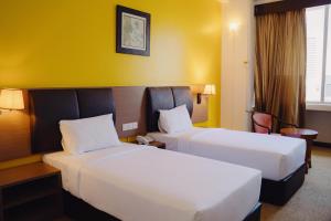 Postel nebo postele na pokoji v ubytování Hotel Sentral Melaka @ City Centre