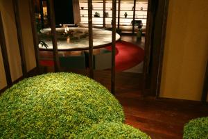 a view of a living room with a table and a bush at Jozankei Daiichi Hotel Suizantei in Jozankei