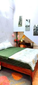 a bed in a room with avertisement for at H2Homestay phố cổ check in tự động in Hanoi
