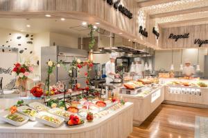 a restaurant with a chef preparing food in a kitchen at TAOYA Saikaibashi in Sasebo