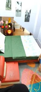 a room with a bed with a green sheet at H2Homestay phố cổ check in tự động in Hanoi
