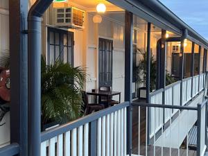 a front porch of a house with white railing at Biloela Hotel in Biloela