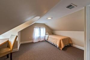 a attic bedroom with a bed and a window at 5 Bdrm House (Sleeps 10) Horsham-Philadelphia in Horsham