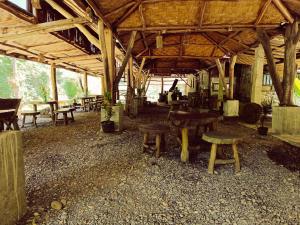 a group of tables and benches in a building at back to nature ecotourism in Bukit Lawang