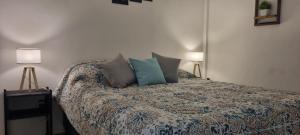 a bedroom with a bed with pillows on it at JUJUY SOHO in San Salvador de Jujuy