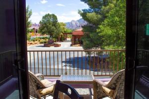 a view of a patio with chairs and a table on a balcony at Carnelian Coyote - Fabulous Condo in West Sedona! in Sedona