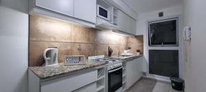 a kitchen with a stove and a counter top at JUJUY SOHO in San Salvador de Jujuy