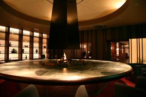 a large round table in a room with a fireplace at Jozankei Daiichi Hotel Suizantei in Jozankei