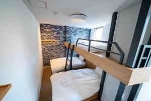 a room with two bunk beds and a staircase at COB HOTEL Asakusa in Tokyo
