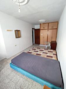 a bedroom with a large bed in a room at Calm place and near to the beach in Monastir