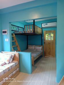 a room with two bunk beds and a staircase at SmallFry's Beach Resort in Calatrava