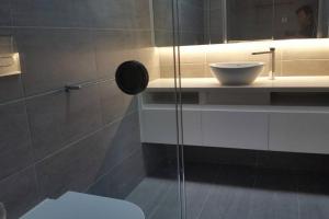 a bathroom with a sink and a toilet and a mirror at 3 BDR Townhouse 200m from station 4 beds in Melbourne