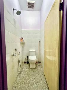 a bathroom with a toilet and a shower at Zaf Homestay Pendang in Pendang