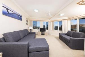 a living room with a couch and a tv at Whitesands 602 in Forster