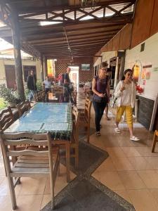 eine Gruppe von Menschen, die in einem Restaurant an einem Tisch spazieren in der Unterkunft WISMA SIBAYAK Guesthouse BERASTAGI in Berastagi