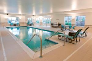 a large swimming pool with chairs and a table at Residence Inn Cincinnati North West Chester in West Chester