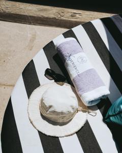 a bird sitting on a table next to a towel at The Xperience by g & Beach Club in Mazatlán