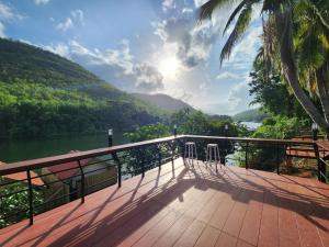 a balcony with a view of a river and mountains at Lake Hill Resort Kanchanaburi in Tha Kradan