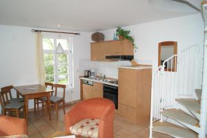 a kitchen and dining room with a table and chairs at Maisionette Wohnung im Hafenmeisterhaus Lauterbach in Lauterbach
