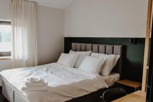 Кровать или кровати в номере JANOWE miejsce spotkań