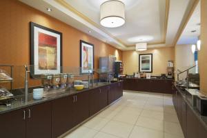 a large kitchen with a counter in a restaurant at Residence Inn Charlotte SouthPark in Charlotte