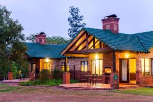 a brick house with a blue roof at Thyme Inn on Greenway in White River