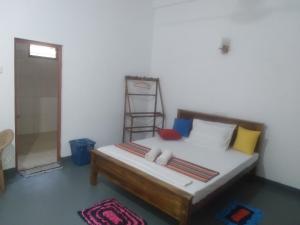 a bedroom with a bed with a ladder in it at Family Nest in Dambulla