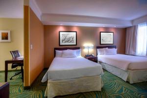 a hotel room with two beds and a desk at SpringHill Suites by Marriott - Tampa Brandon in Tampa