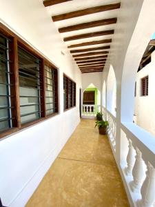 a hallway of a house with a wooden ceiling at Beautiful Mafriza Apartment in Lamu