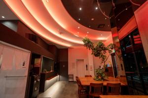 a dining room with a table and a ceiling with lights at COB HOTEL Asakusa in Tokyo