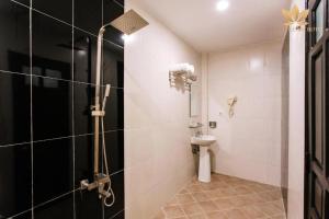 a bathroom with a shower and a toilet at Lotus Village Hotel - 68 Hàng Bồ - by Bay Luxury in Hanoi