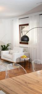 a living room with a white couch and a table at Apartment "Istra Inspirita II" in Rovinj