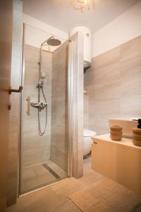 a shower with a glass door in a bathroom at Apartment "Istra Inspirita II" in Rovinj