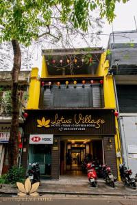 a store with motorcycles parked in front of it at Lotus Village Hotel - 68 Hàng Bồ - by Bay Luxury in Hanoi