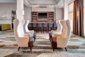 a lobby with three chairs and a bar at Residence Inn by Marriott Cleveland Downtown in Cleveland