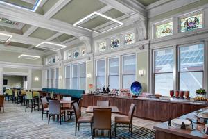 a dining room with tables and chairs and stained glass windows at Residence Inn by Marriott Cleveland Downtown in Cleveland