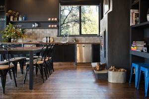 a kitchen with a table and chairs and a window at The Clubhouse in Hepburn