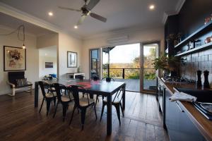 a kitchen and dining room with a table and chairs at The Clubhouse in Hepburn