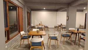 a room with tables and chairs in a restaurant at Windmill Inn in Solan