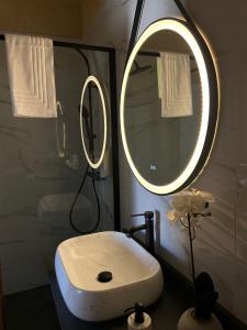 a bathroom with a white sink and a mirror at Sea Holly Gozo in Nadur
