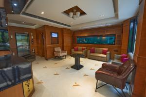 a large living room with a table and chairs at Hotel Prestige, Mangalore in Mangalore