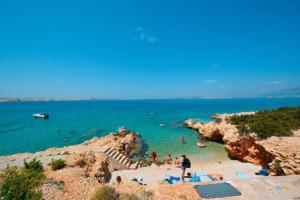 a group of people in the water at a beach at Apartment Zmisa in Stara Novalja