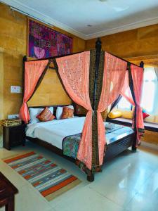 a bedroom with a bed with a canopy at Hotel Royal Heritage in Jaisalmer