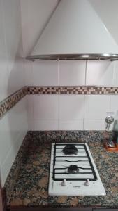 a stove in a kitchen with a counter top at ALBERTI APARTAMENTS in Campana