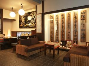 a waiting room with couches and chairs in a restaurant at Kisoji no Yado Iwaya in Kiso