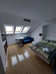 a bedroom with a bed and two skylights at Ancora apartment 5 in Novi Sad +5 photos