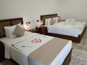 Voodi või voodid majutusasutuse Sigiriya Cashew Palace Resort toas